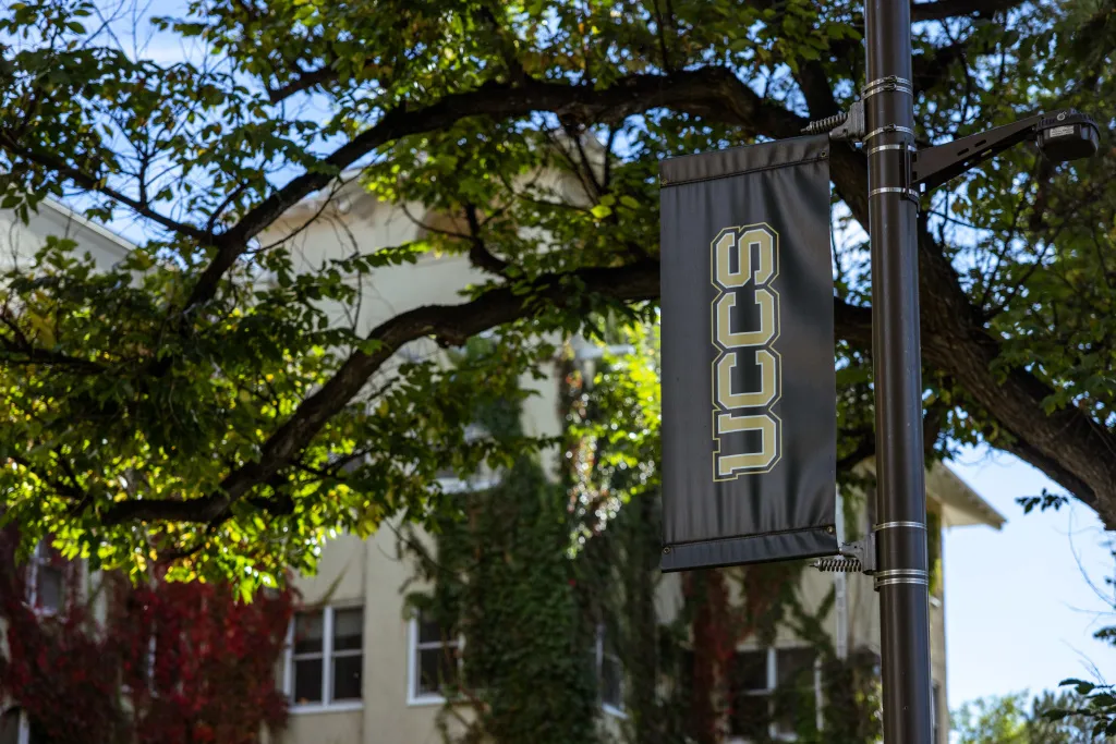 UCCS flag with Main Hall in the background