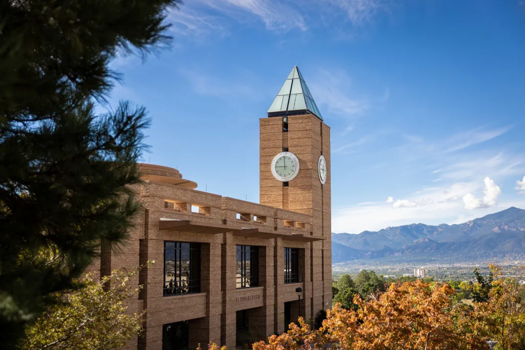 El Pomar Tower with fall foliage and mountains in the background